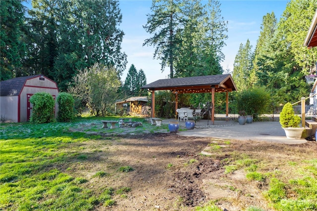 view of yard featuring a patio area, a gazebo, and a shed