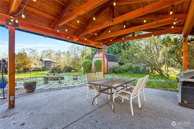 view of patio / terrace with a storage unit, a gazebo, and a fire pit