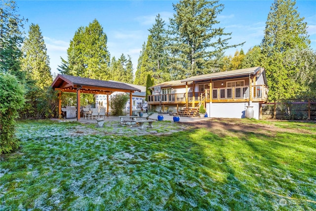 view of yard with a deck, an outdoor fire pit, and a patio