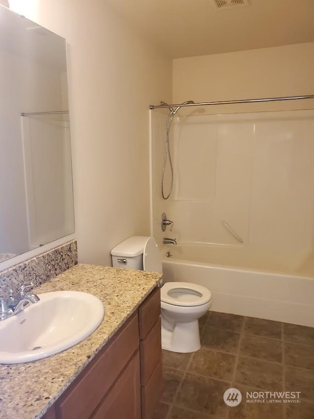 full bathroom with vanity with extensive cabinet space, toilet, tub / shower combination, and tile flooring