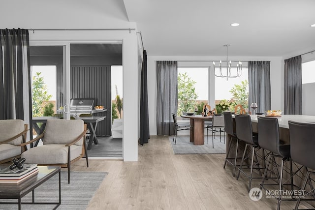 dining area featuring a notable chandelier and light hardwood / wood-style floors