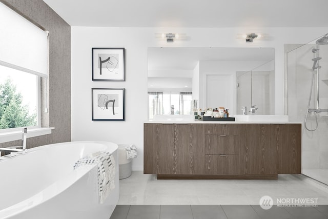 bathroom featuring shower with separate bathtub, a healthy amount of sunlight, large vanity, and tile flooring