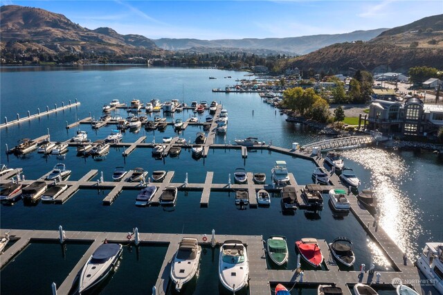 drone / aerial view with a water and mountain view