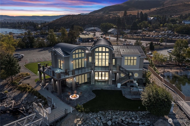 aerial view at dusk featuring a mountain view