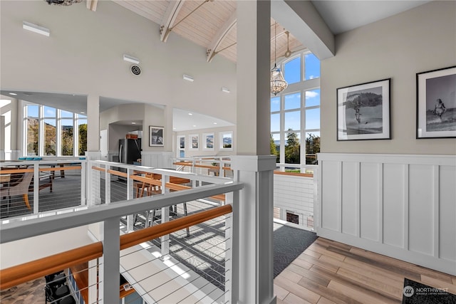 interior space featuring high vaulted ceiling, wood ceiling, beam ceiling, and light hardwood / wood-style floors