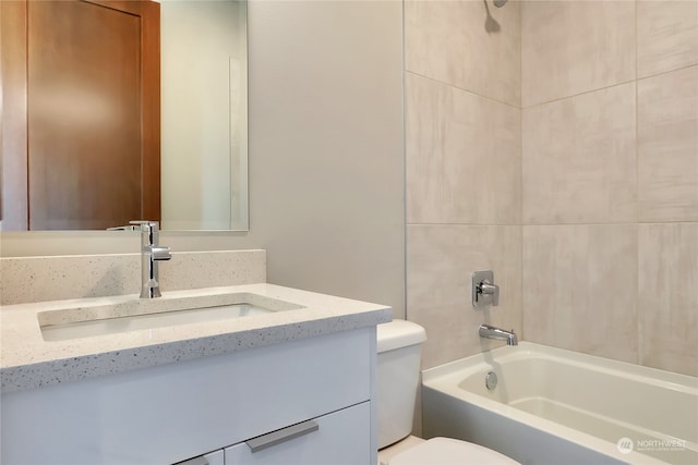 full bathroom with tiled shower / bath combo, toilet, and vanity