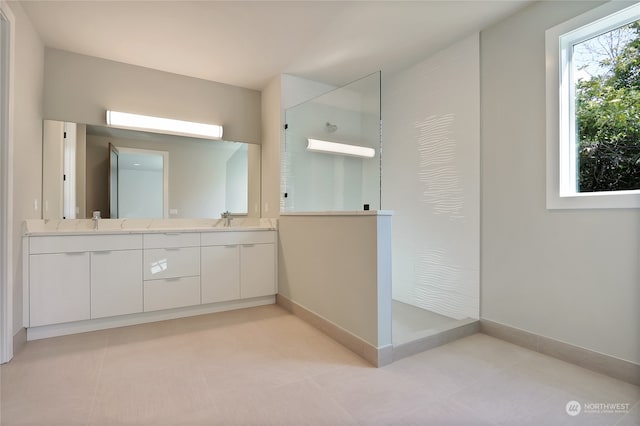 bathroom with walk in shower, dual sinks, tile floors, and oversized vanity