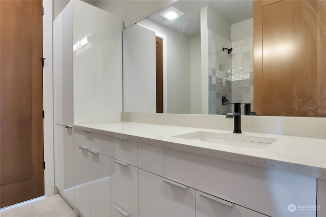 bathroom featuring vanity with extensive cabinet space and tile floors