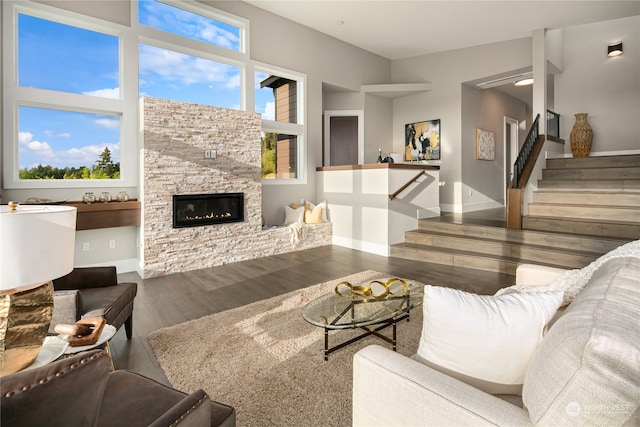 living room with a fireplace, dark hardwood / wood-style floors, and plenty of natural light