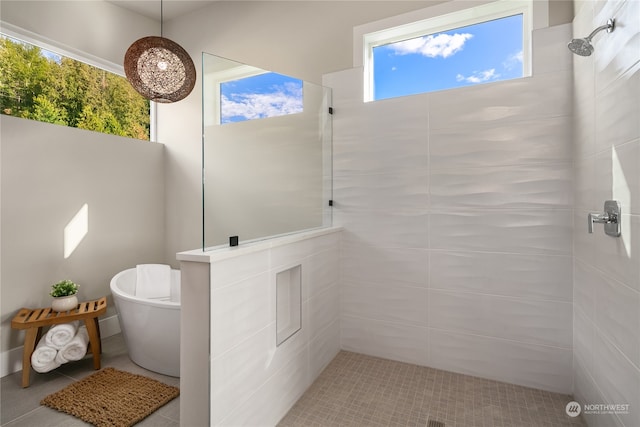 bathroom featuring a tile shower and tile flooring