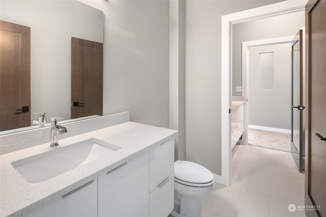 bathroom featuring tile floors, toilet, and vanity