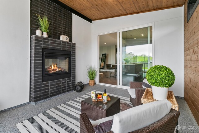 view of patio featuring an outdoor living space with a fireplace