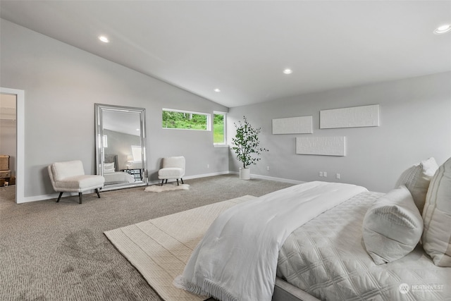 bedroom with carpet flooring, a walk in closet, and vaulted ceiling