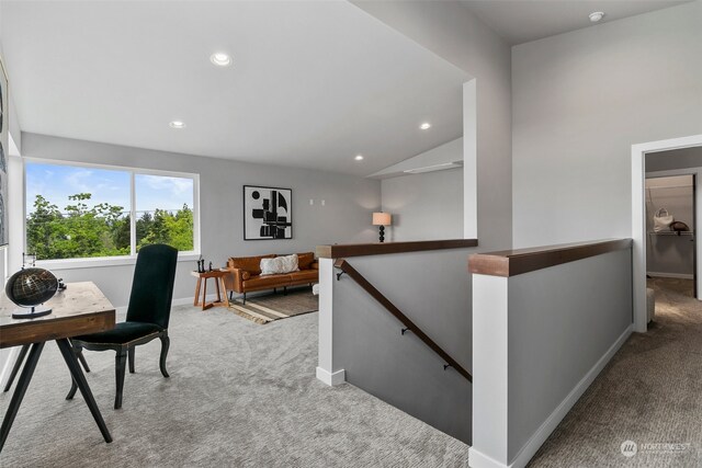 carpeted office space featuring vaulted ceiling