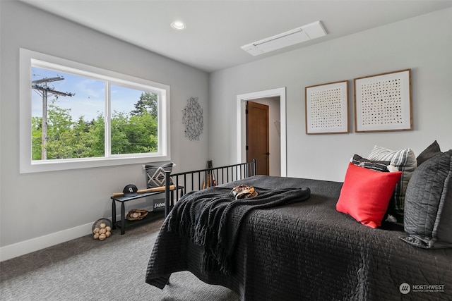 bedroom featuring multiple windows and carpet