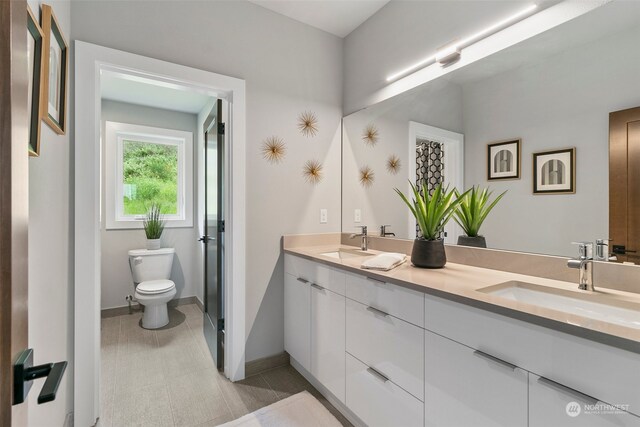 bathroom featuring vanity and toilet