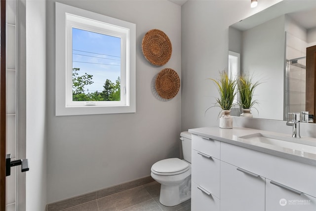 bathroom featuring vanity, a shower with shower door, and toilet