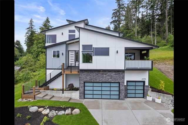 modern home with a garage and a balcony