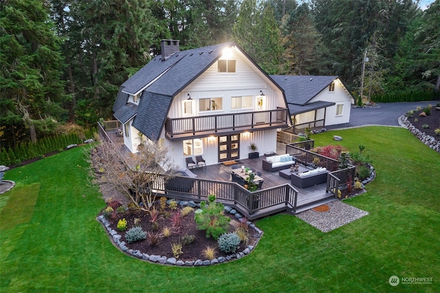 rear view of property with a deck, a balcony, outdoor lounge area, and a yard