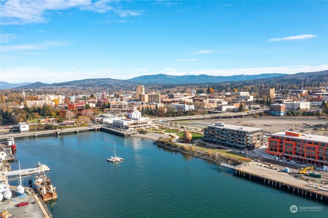 aerial view featuring a city view and a water and mountain view