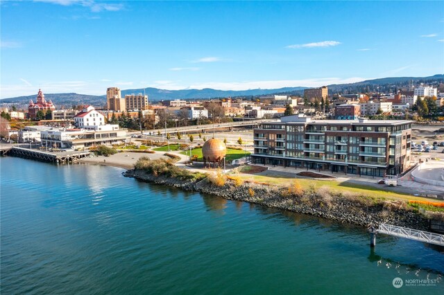 birds eye view of property featuring a view of city and a water and mountain view