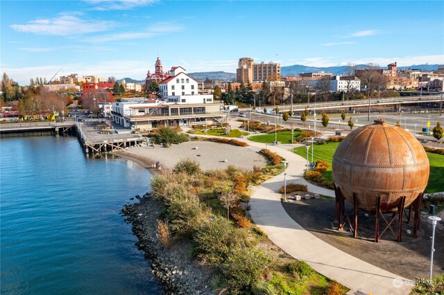 aerial view featuring a view of city and a water and mountain view