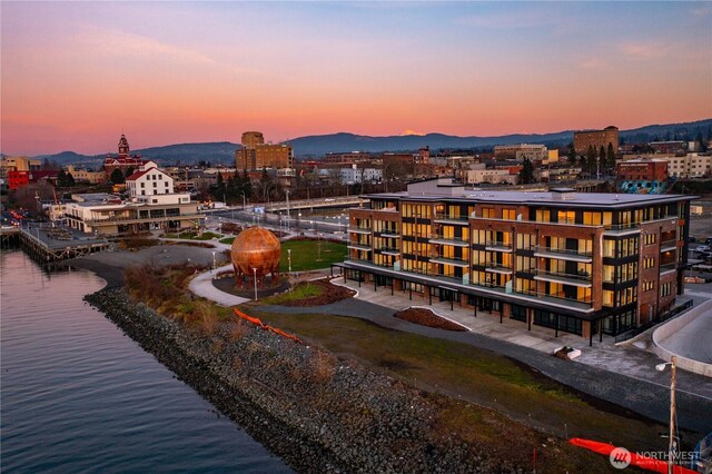 birds eye view of property featuring a water and mountain view and a city view