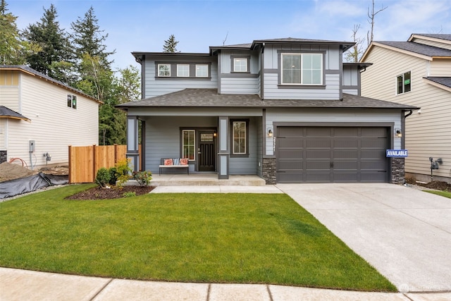 view of front facade featuring a porch, a garage, and a front lawn