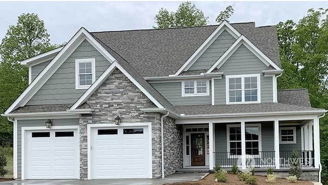 craftsman inspired home with covered porch and a garage