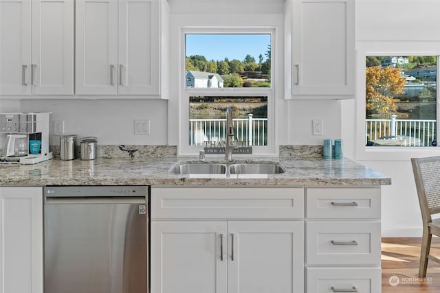 kitchen with sink, white cabinets, dishwasher, and a wealth of natural light