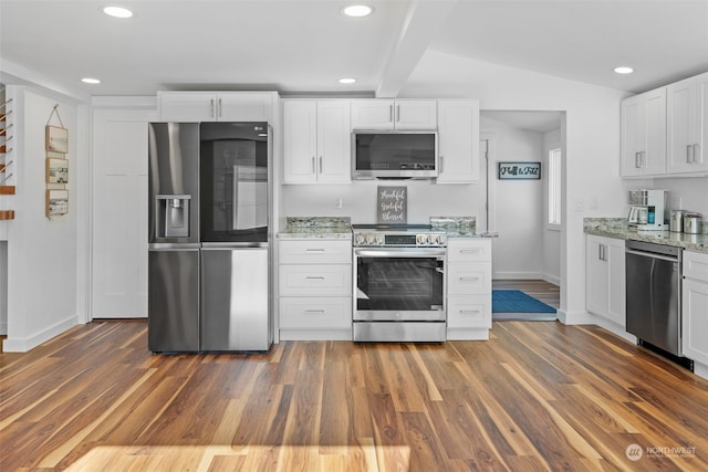 kitchen with light stone countertops, white cabinetry, dark wood-type flooring, appliances with stainless steel finishes, and lofted ceiling with beams