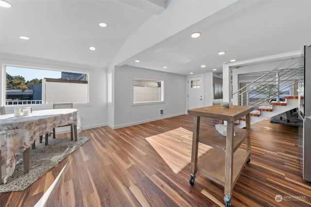 interior space featuring lofted ceiling with beams, dark hardwood / wood-style floors, and a wealth of natural light