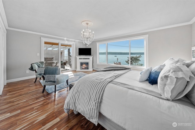 bedroom featuring an inviting chandelier, crown molding, dark hardwood / wood-style floors, and a water view