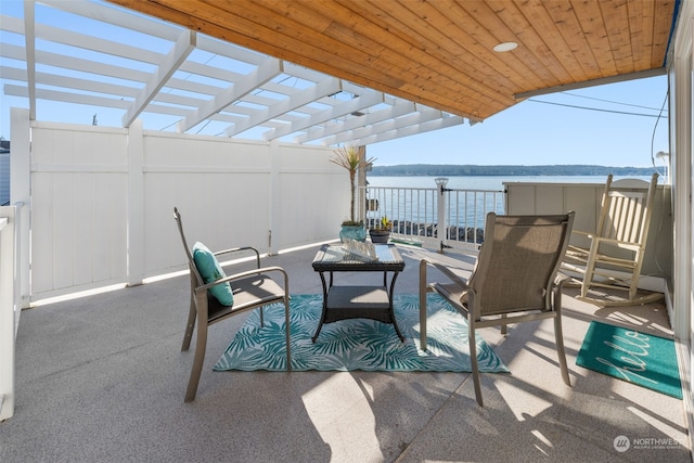 view of patio / terrace featuring a pergola and a water view