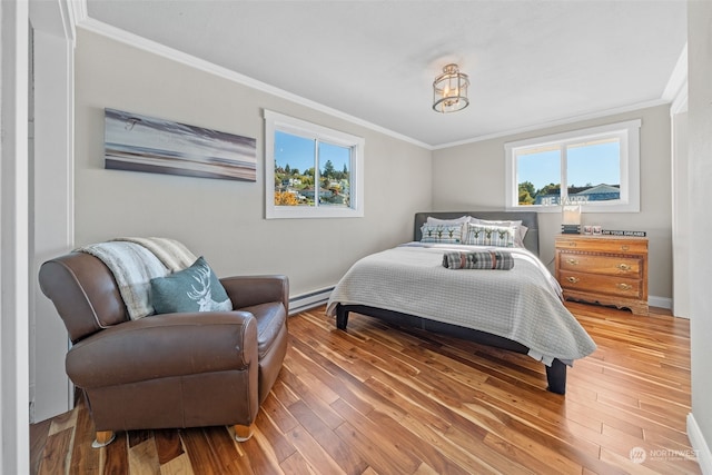 bedroom with baseboard heating, ornamental molding, and wood-type flooring