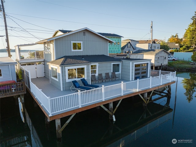 back of property with a balcony and a deck