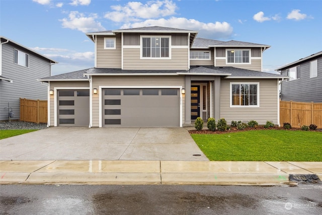 view of front of home featuring a garage and a front lawn