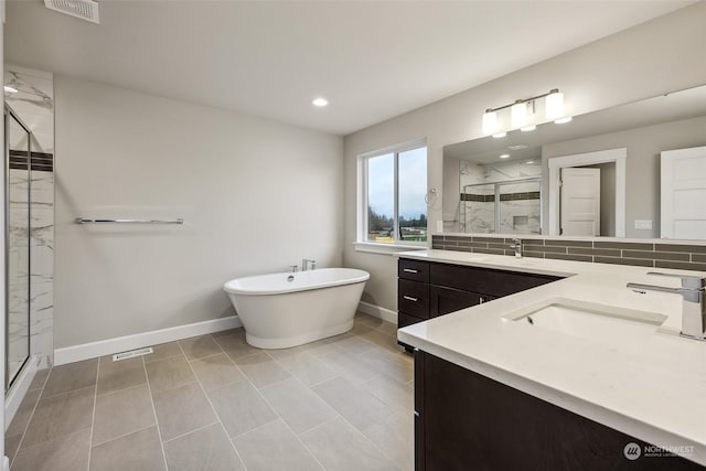 bathroom with decorative backsplash, tile patterned flooring, vanity, and plus walk in shower