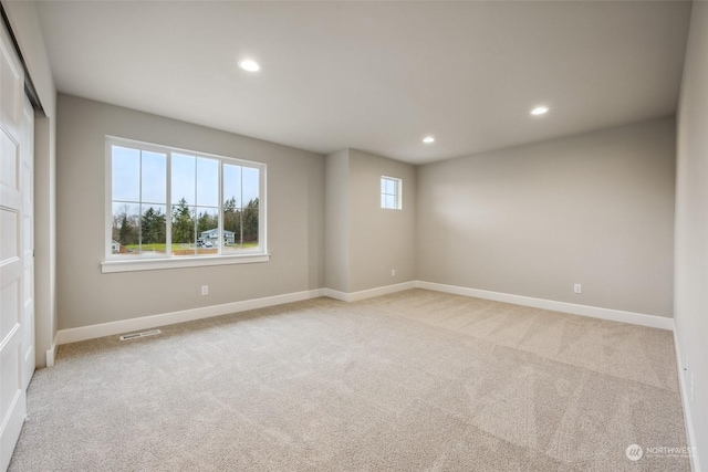 unfurnished room with light carpet