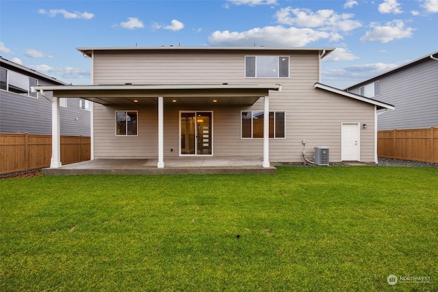 rear view of property with a yard, a patio, and central AC unit