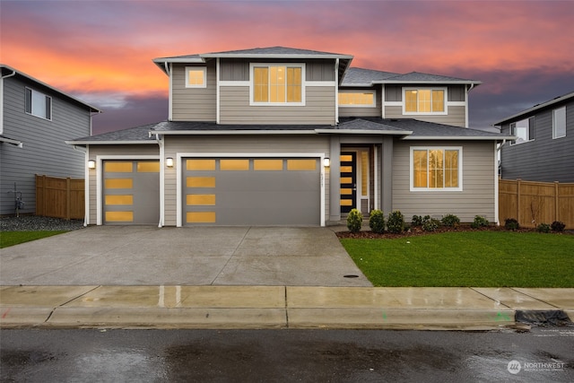 view of front facade with a garage and a yard