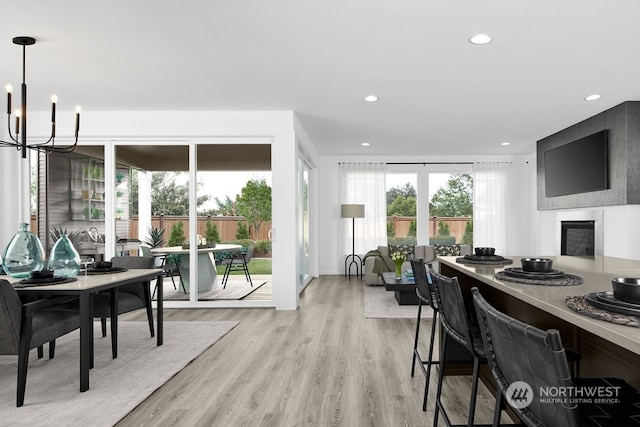 office featuring an inviting chandelier and light hardwood / wood-style floors