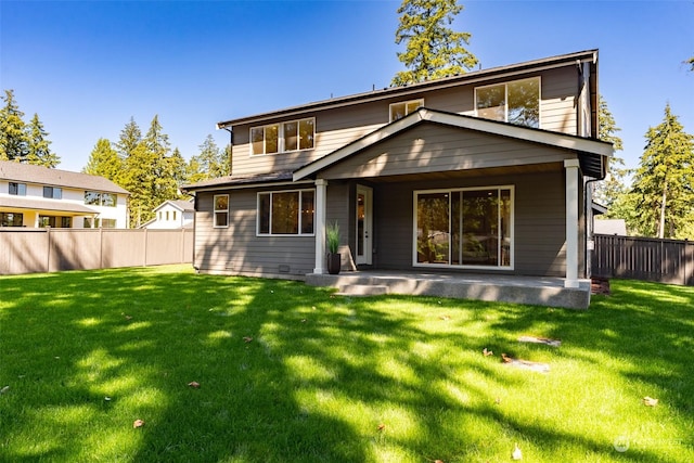 back of house with a yard, fence, and a patio