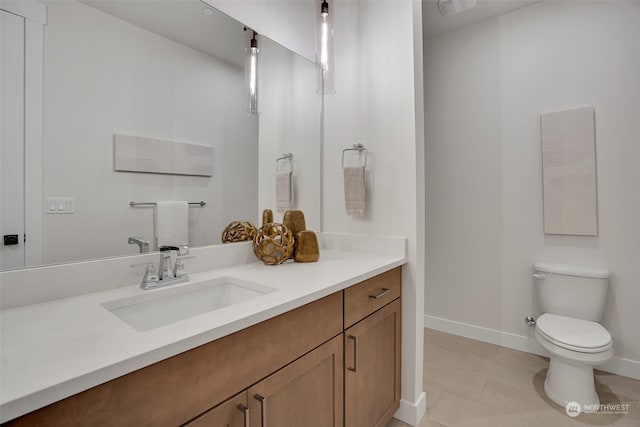 bathroom with toilet, tile patterned floors, and vanity