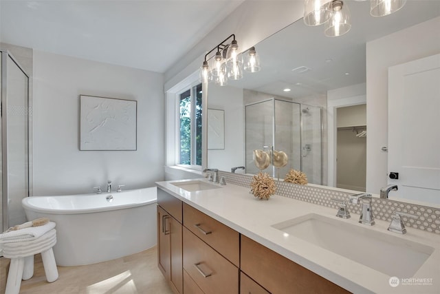 full bathroom with a freestanding tub, a sink, a shower stall, and double vanity