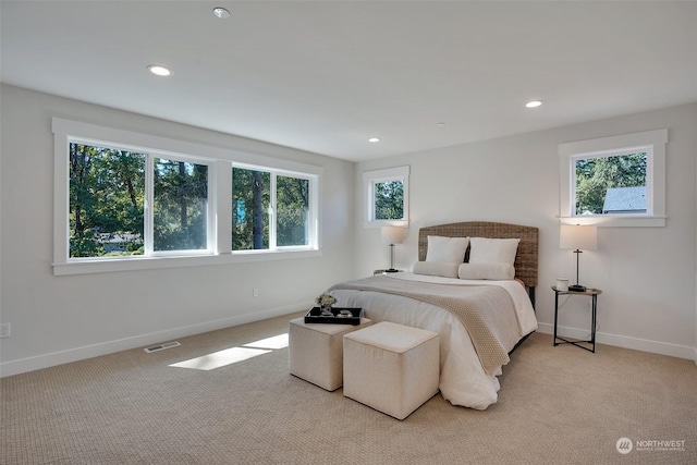 bedroom featuring recessed lighting, light colored carpet, visible vents, and baseboards