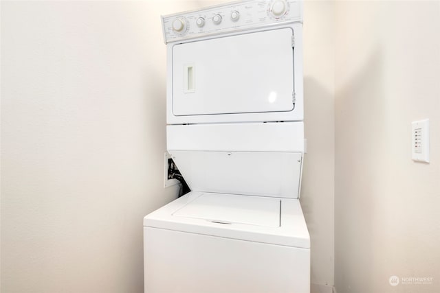 clothes washing area featuring washer hookup and stacked washer and dryer