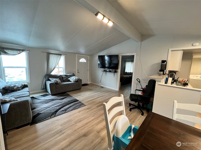 living room with lofted ceiling with beams and light wood-type flooring