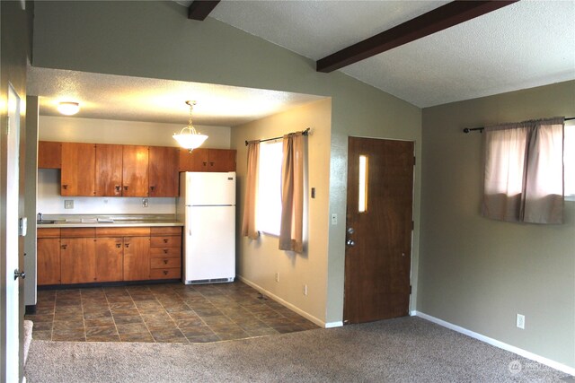 kitchen featuring white fridge, dark colored carpet, lofted ceiling with beams, and pendant lighting