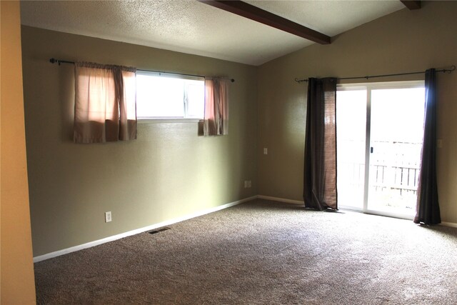 carpeted spare room with plenty of natural light, a textured ceiling, and vaulted ceiling with beams